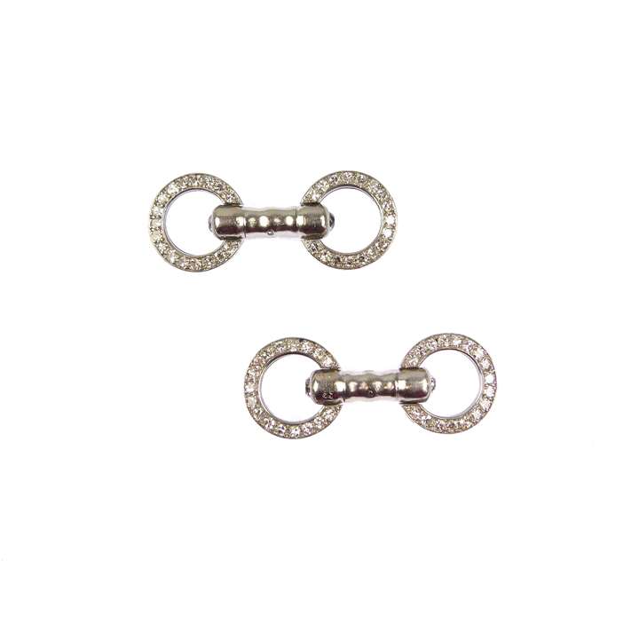Pair of diamond and platinum circular dumbbell cufflinks by Cartier